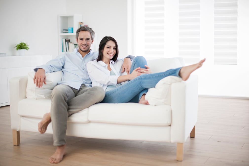 Couple at home relaxing in sofa